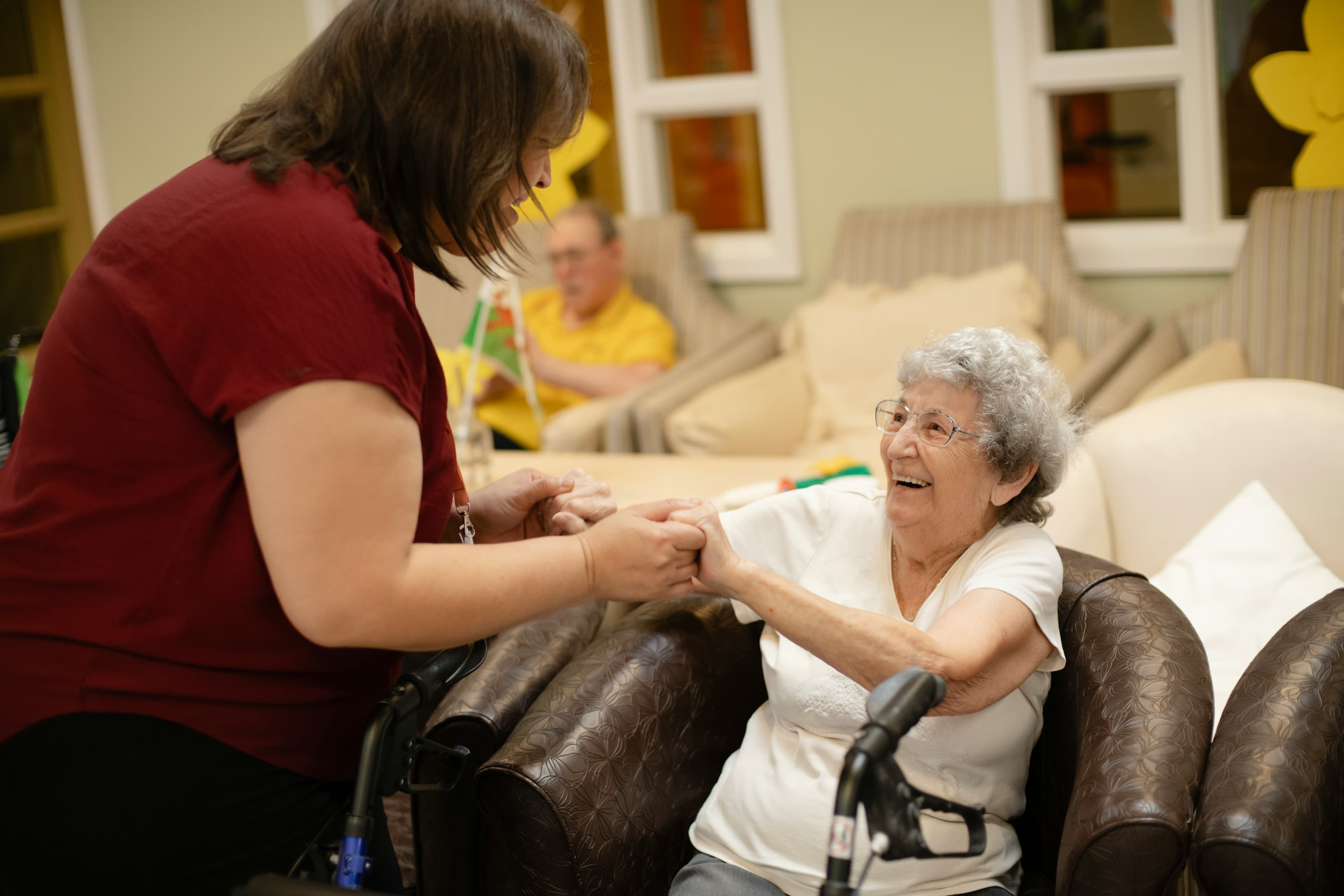 A family caregiver and a senior loved one sharing a comfortable moment at home.